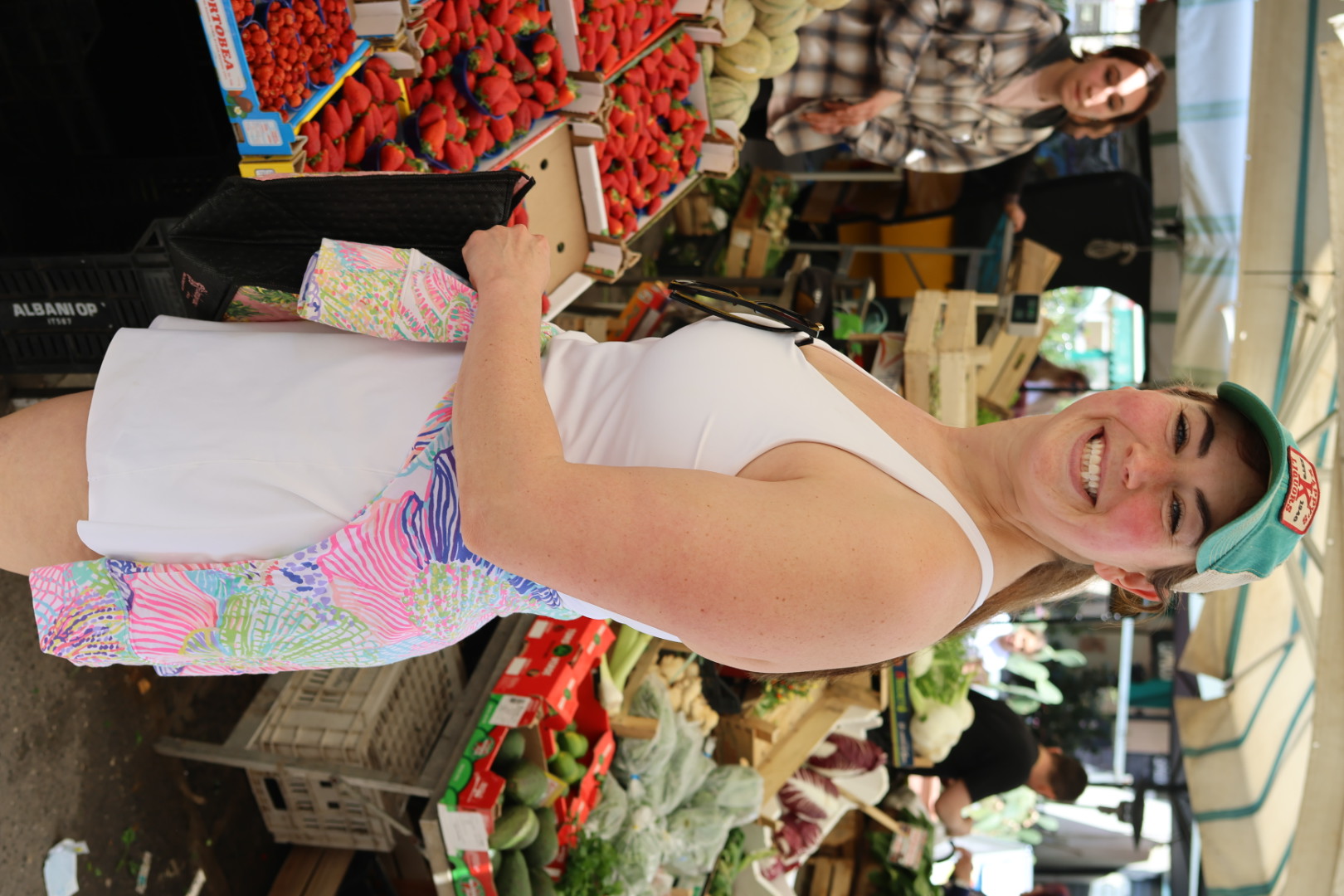 Molly shopping among fresh produce at a Sicilian market